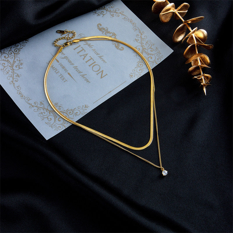 Elegant gold-toned layered necklace for women with two chains and a charming pendant, a perfect fashion accessory.