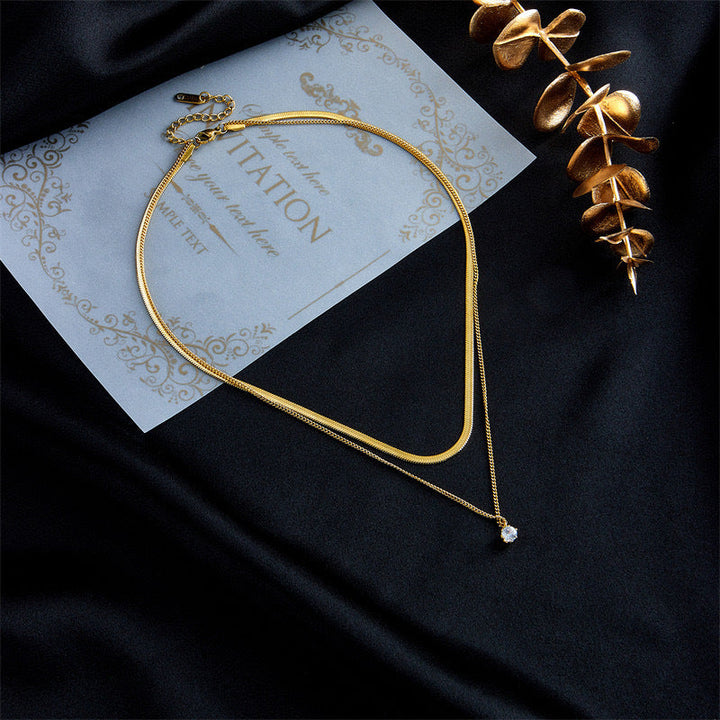 Elegant gold-toned layered necklace for women with two chains and a charming pendant, a perfect fashion accessory.