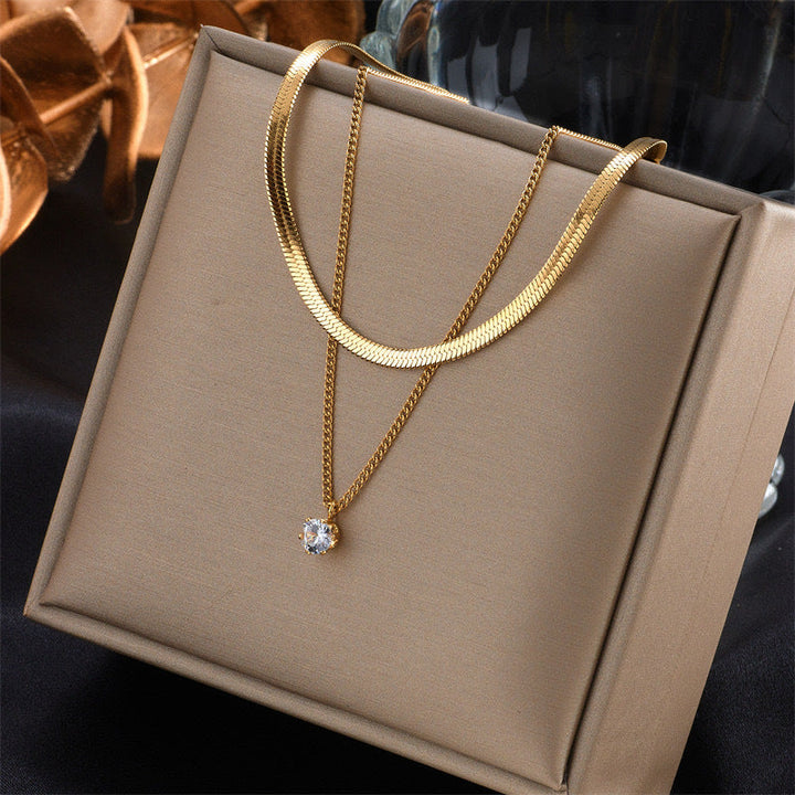Delicate women's layered gold necklace with dual chains and a minimalist pendant, a chic everyday accessory.