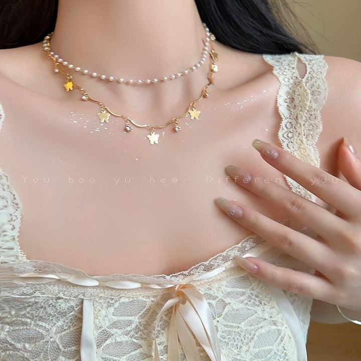 Elegant women's layered opal charm necklace with delicate pearls, perfect for a whimsical look.