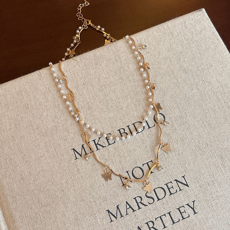 Women's elegant layered jewelry set: opal & pearl charm necklace and matching bracelet.