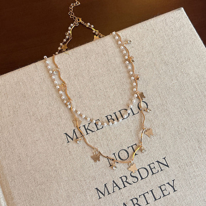 Women's elegant layered jewelry set: opal & pearl charm necklace and matching bracelet.