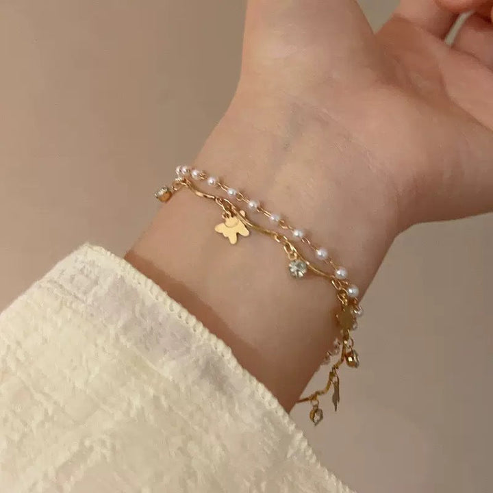 Stylish layered bracelet for women, adorned with charming opal and pearl elements, elegant jewelry.