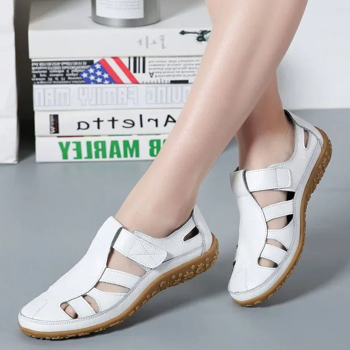 Everyday women's comfort sandals in black leather with adjustable Velcro straps for a custom fit.