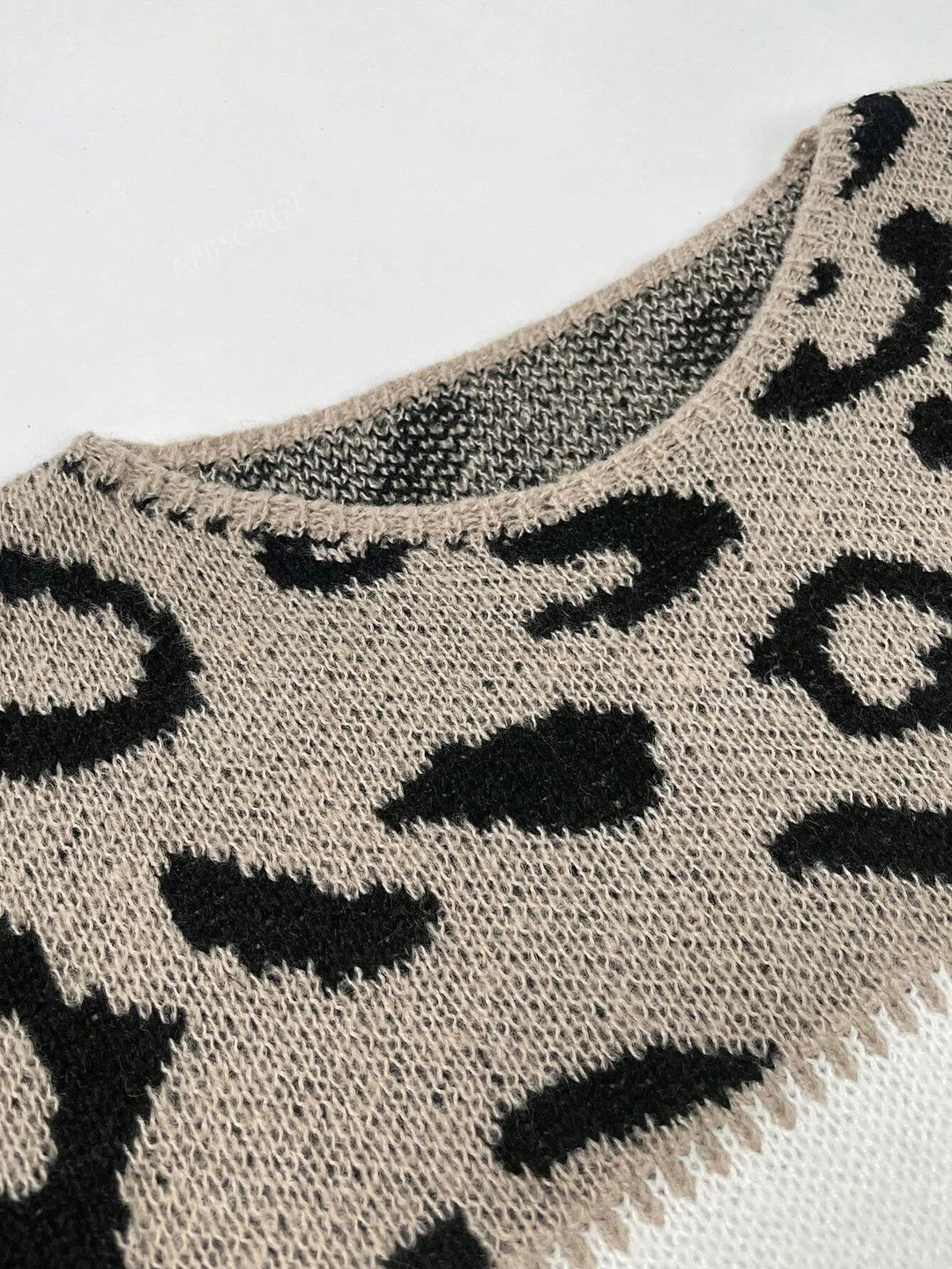 Autumn essential: women's leopard print color block sweater. Stylish, cozy, & features ribbed cuffs.