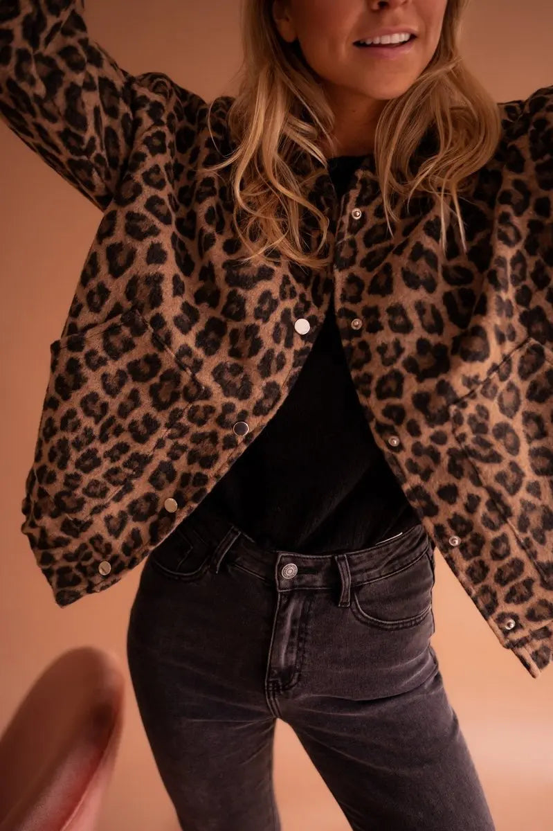 Oversized women's leopard print quilted jacket with press studs, stylish & casual autumn outerwear statement.