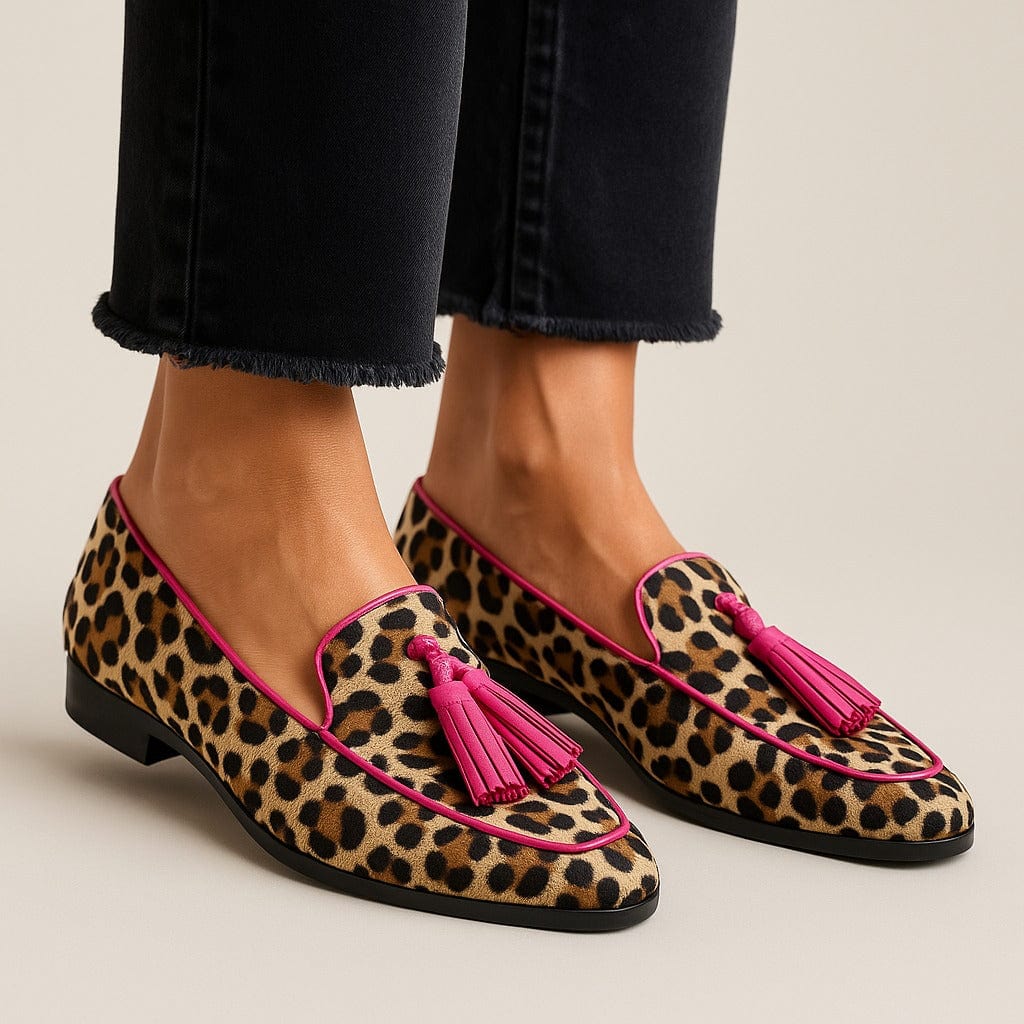 Women's leopard print tassel loafers with fringe detail. Stylish animal print flats for casual fashion footwear.