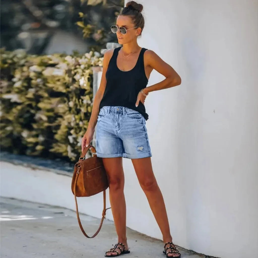 Women's light blue high-waist distressed denim shorts with a chic rolled hem, perfect for summer casual outfits.
