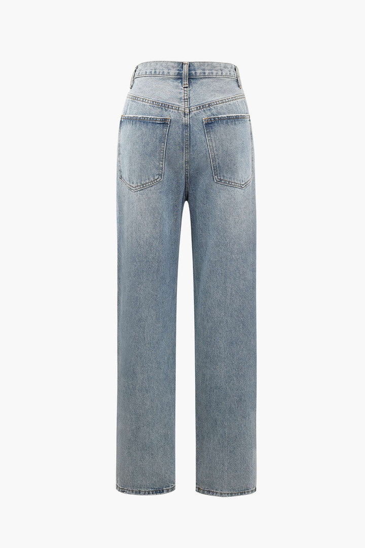 Unique women's straight-leg jeans with an edgy asymmetric high waist and light wash, perfect for modern style.