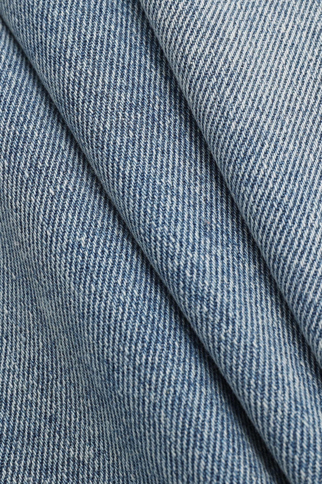 Stylish women's high-waisted straight-leg jeans in light wash, featuring an asymmetric detail for edgy fashion.