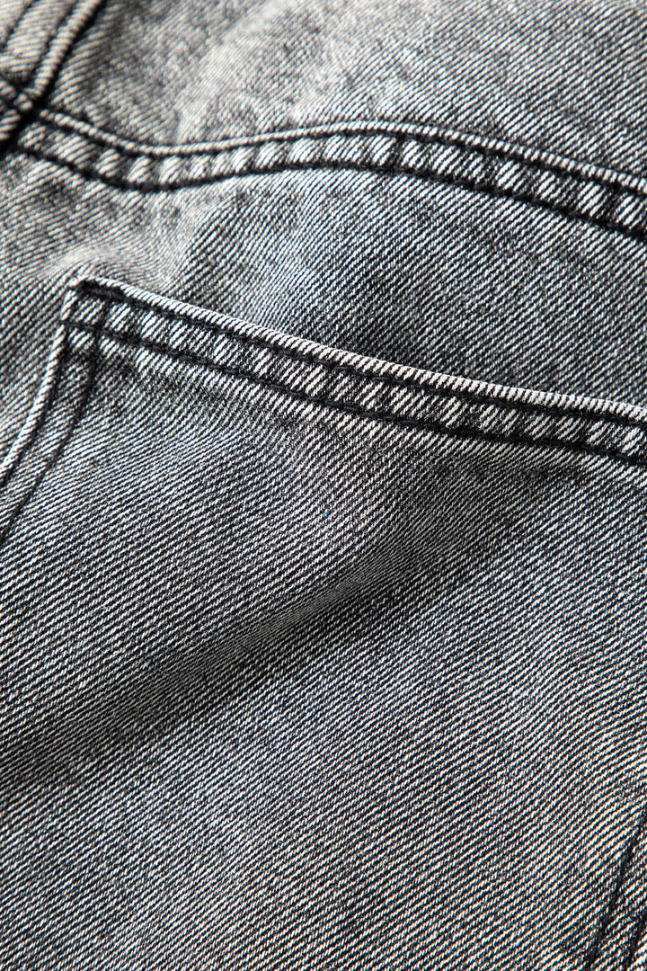 Distinctive women's asymmetric high-waisted straight-leg jeans in a light wash for an edgy, modern aesthetic.