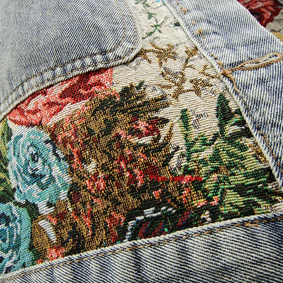 Chic women's light wash denim jacket with beautiful floral embroidery, a versatile fashion jacket.