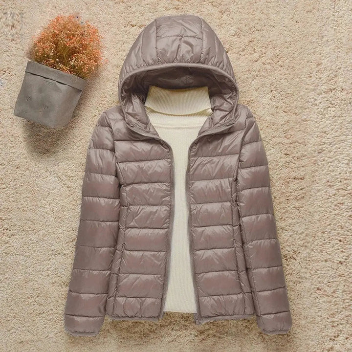 Women's Lightweight Hooded Puffer Jacket, perfect for travel & everyday wear. Packable quilted design.