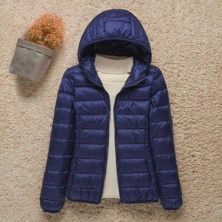 Stylish women's quilted puffer jacket with hood. Lightweight & packable, ideal for autumn & winter travel.