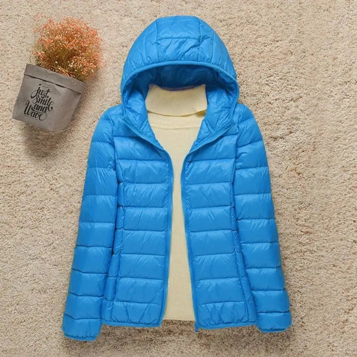 Versatile women's hooded puffer jacket. Lightweight, packable & quilted for ultimate comfort & warmth.