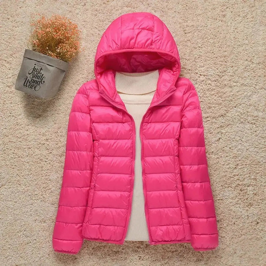 Elegant women's hooded puffer, quilted for warmth. Lightweight & packable, a versatile travel jacket.