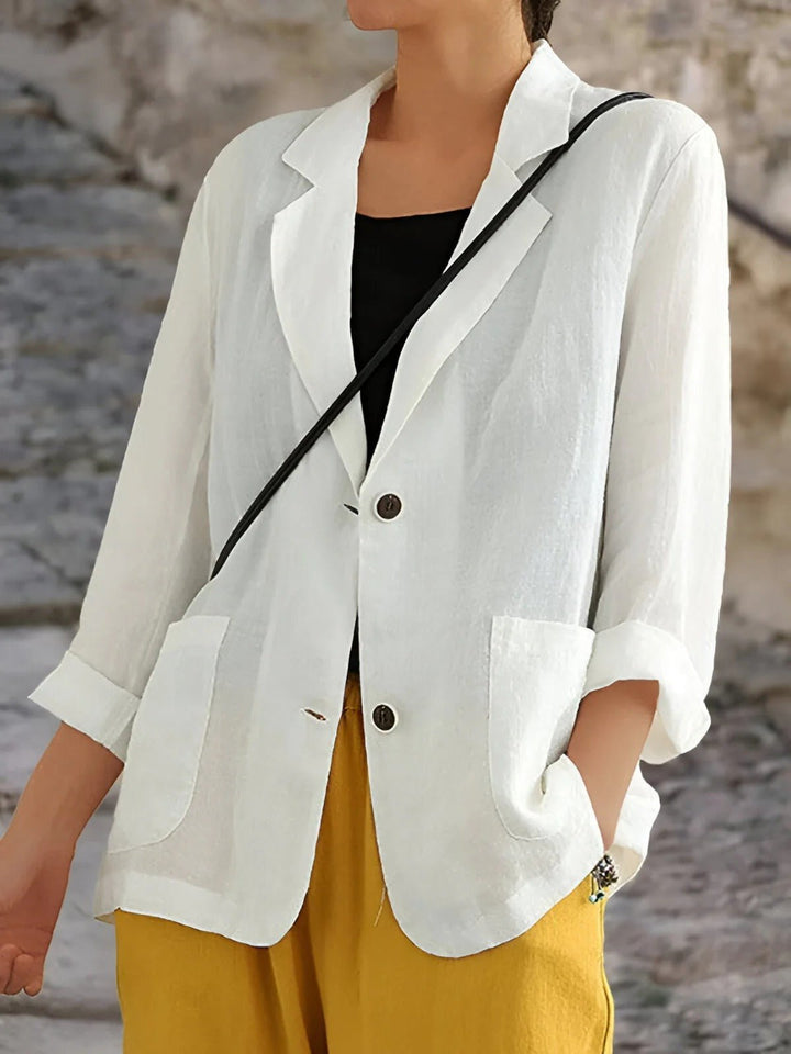 Lightweight women's tailored blazer with pockets, ideal for versatile layering & comfortable smart casual or office wear.