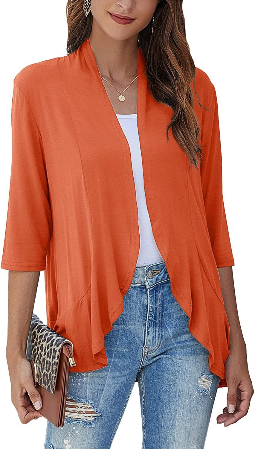 Casual chic: Woman in a lightweight open-front cardigan paired with jeans for effortless everyday style.