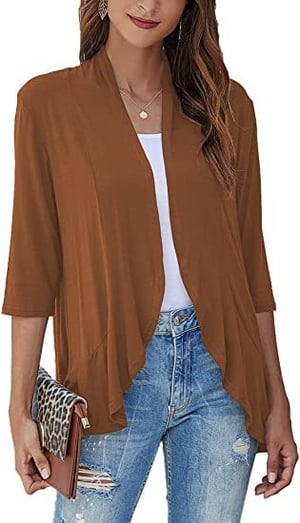 Stylish woman wearing a lightweight open-front cardigan layered over a top. Effortless everyday fashion.