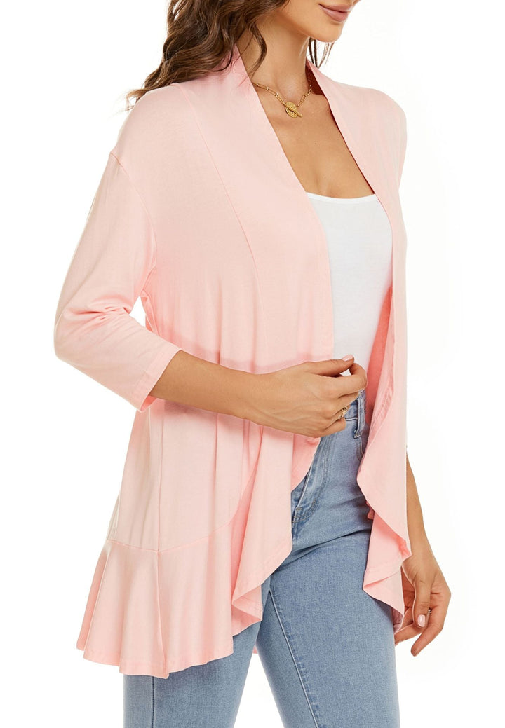 Woman walking confidently in a flowing lightweight open-front cardigan, embodying dynamic casual fashion.