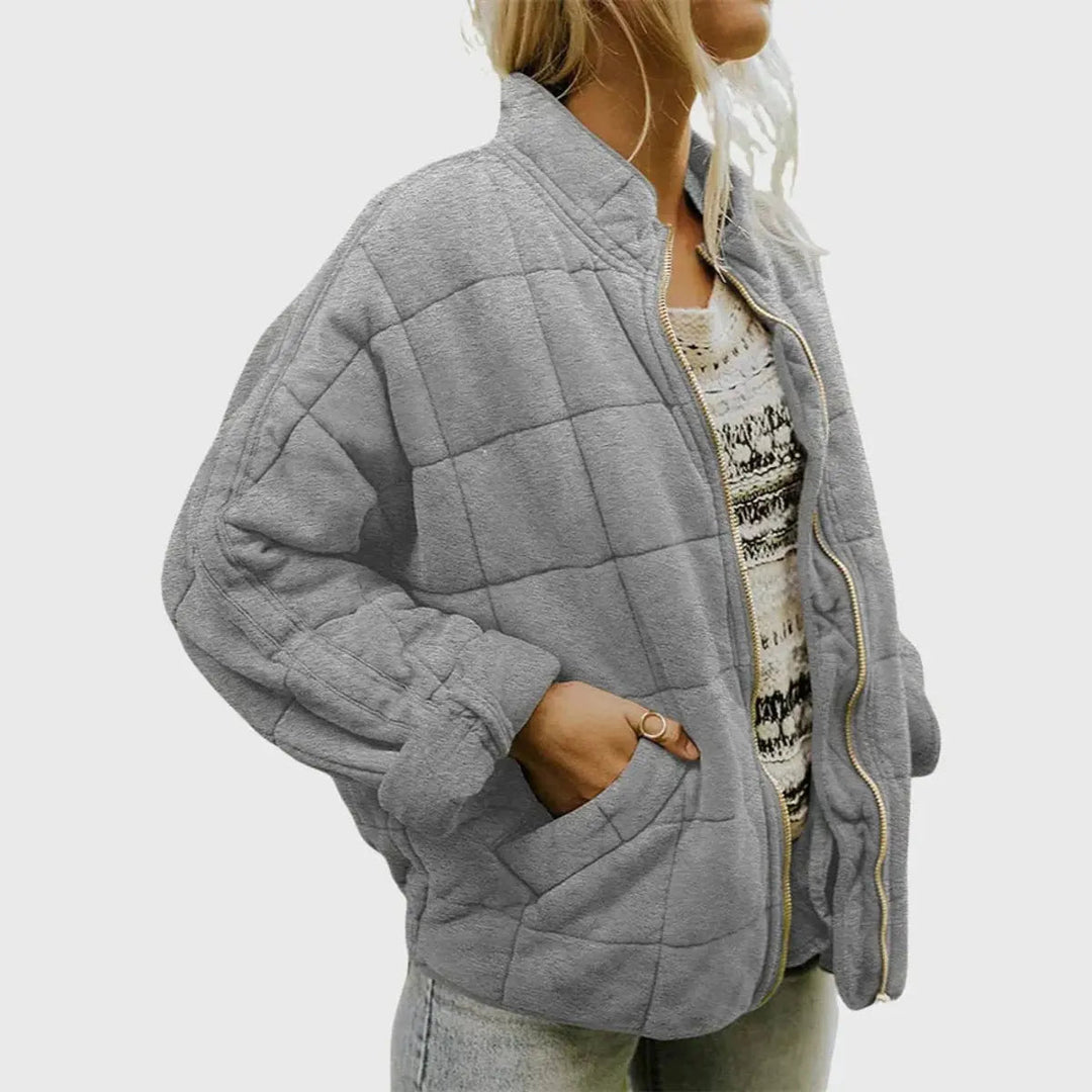 Casual women's quilted jacket with zip-up closure & stand collar. Lightweight, padded, essential for fall fashion.