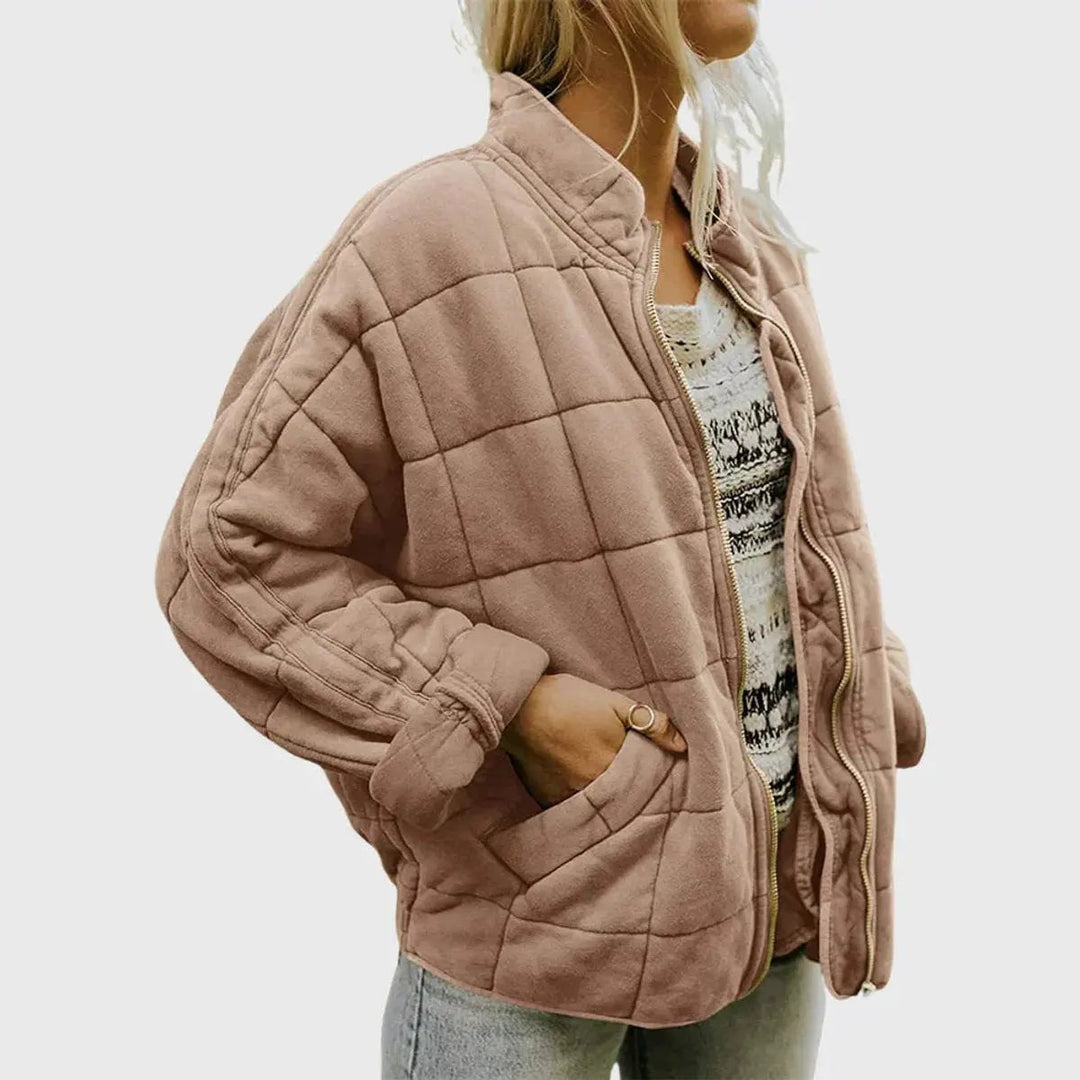 Model wearing a lightweight women's quilted jacket, zip-up, with a stand collar. Perfect for fall casual outings.