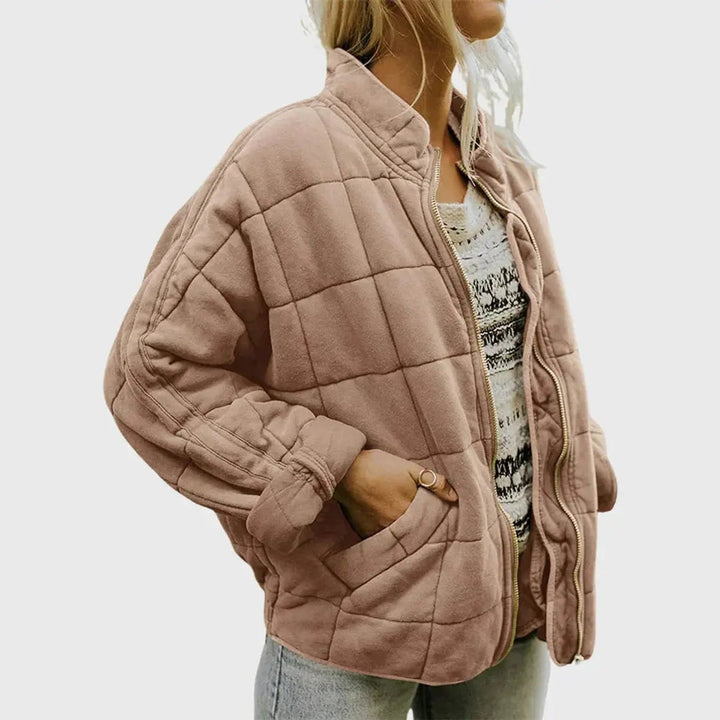 Model wearing a lightweight women's quilted jacket, zip-up, with a stand collar. Perfect for fall casual outings.