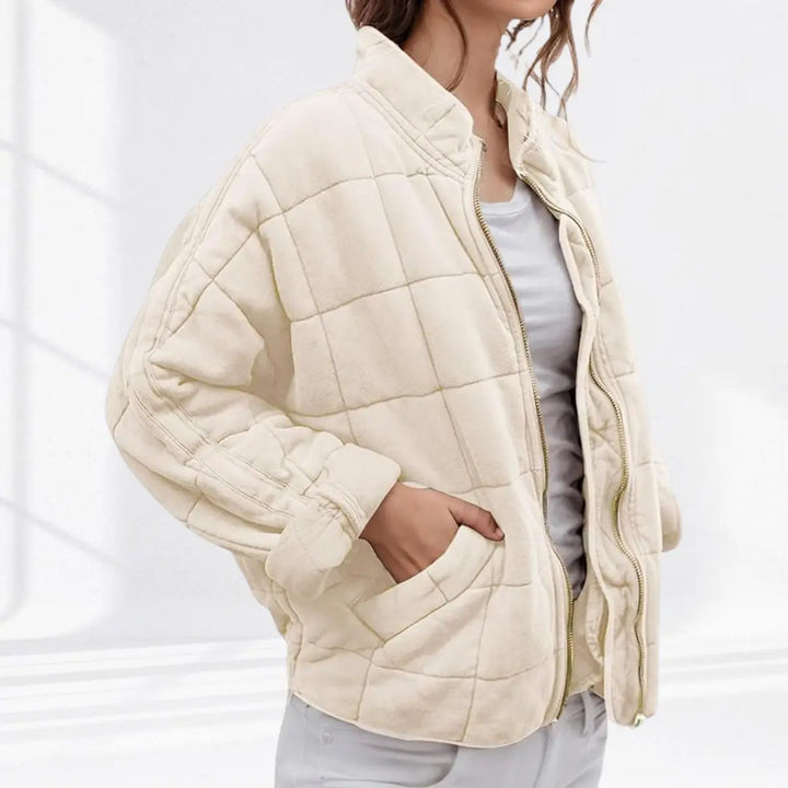 Modern women's lightweight quilted jacket. Zip-up, padded, stand collar. Essential versatile fall fashion outerwear.