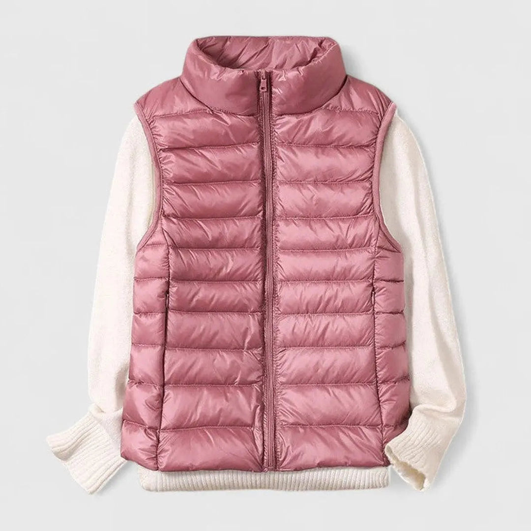 Chic women's sleeveless puffer gilet with stand collar and full zip. Ideal lightweight outerwear for casual style.