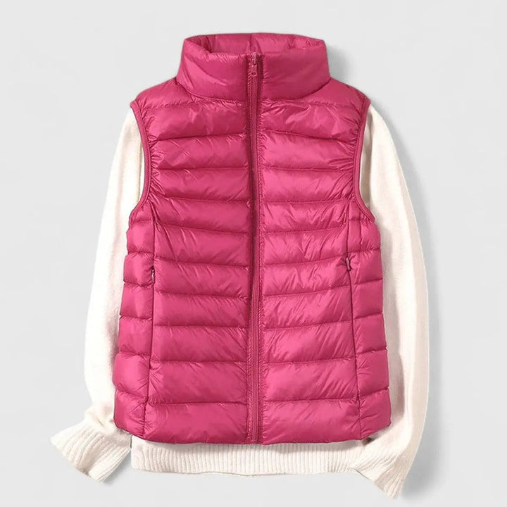 Stylish women's lightweight quilted puffer vest. This sleeveless gilet adds warmth to any outfit.