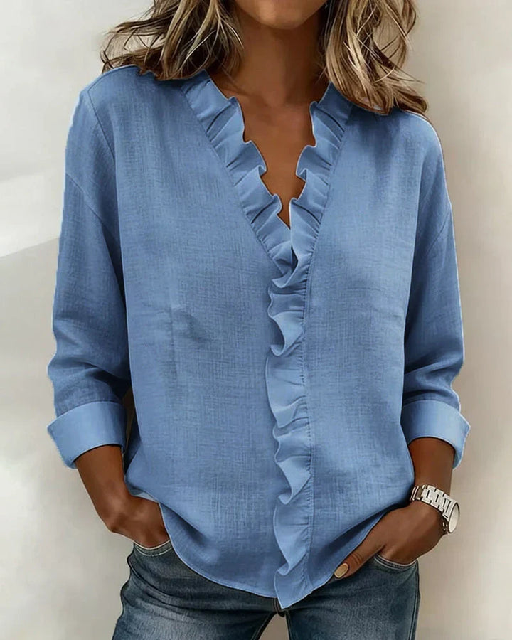 Versatile long sleeve V-neck blouse for women. Features charming ruffles for a chic look.
