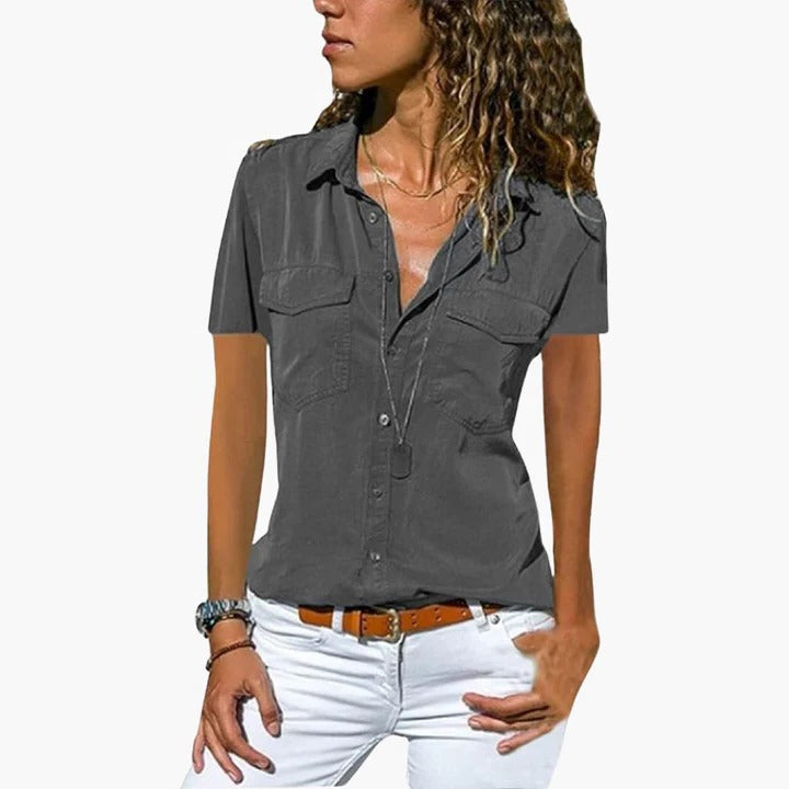 Close-up of a women's lightweight short sleeve button-up shirt with a relaxed fit. Trendy summer casual wear top.