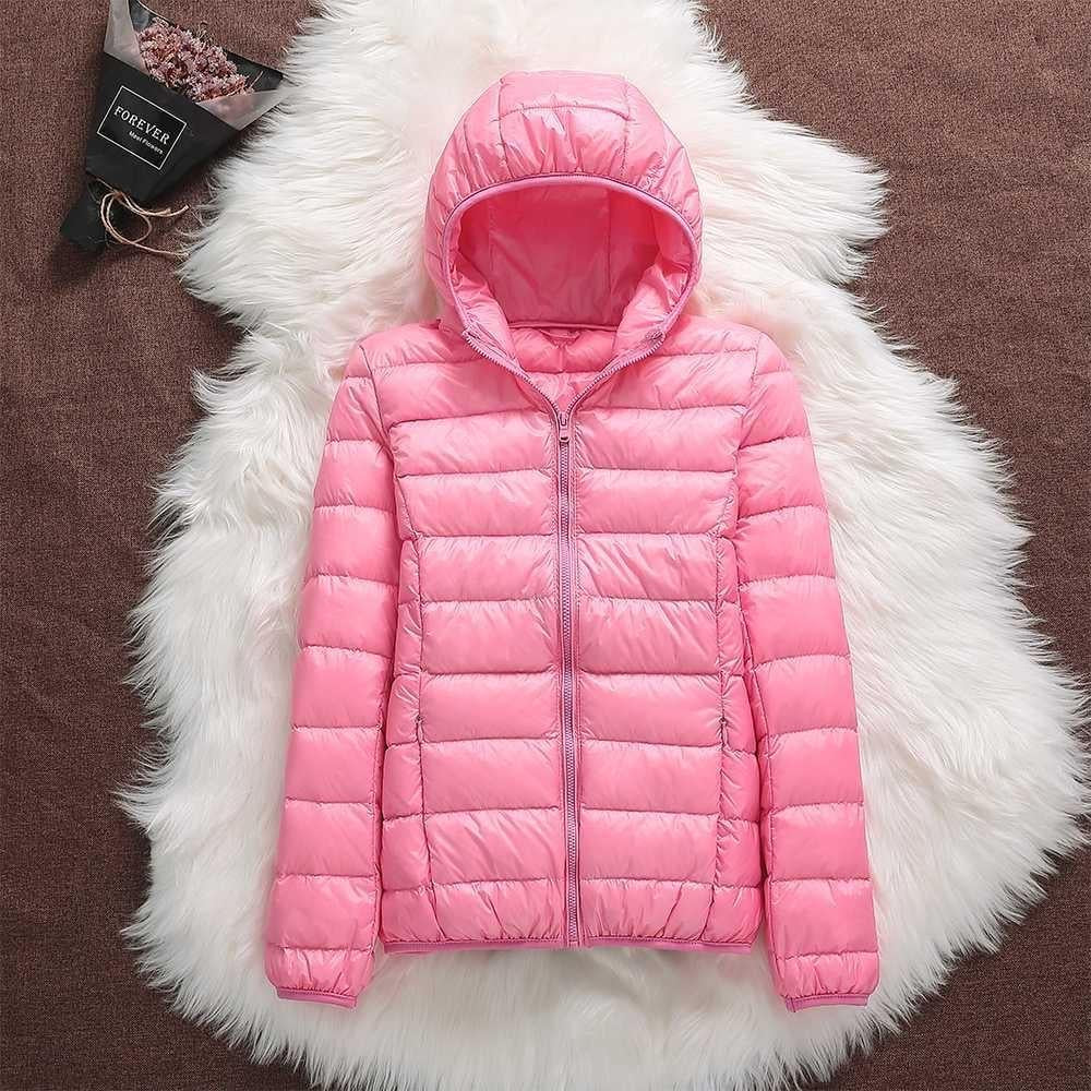 Modern women's waterproof down jacket, lightweight and warm, stylish outerwear for cold climates.