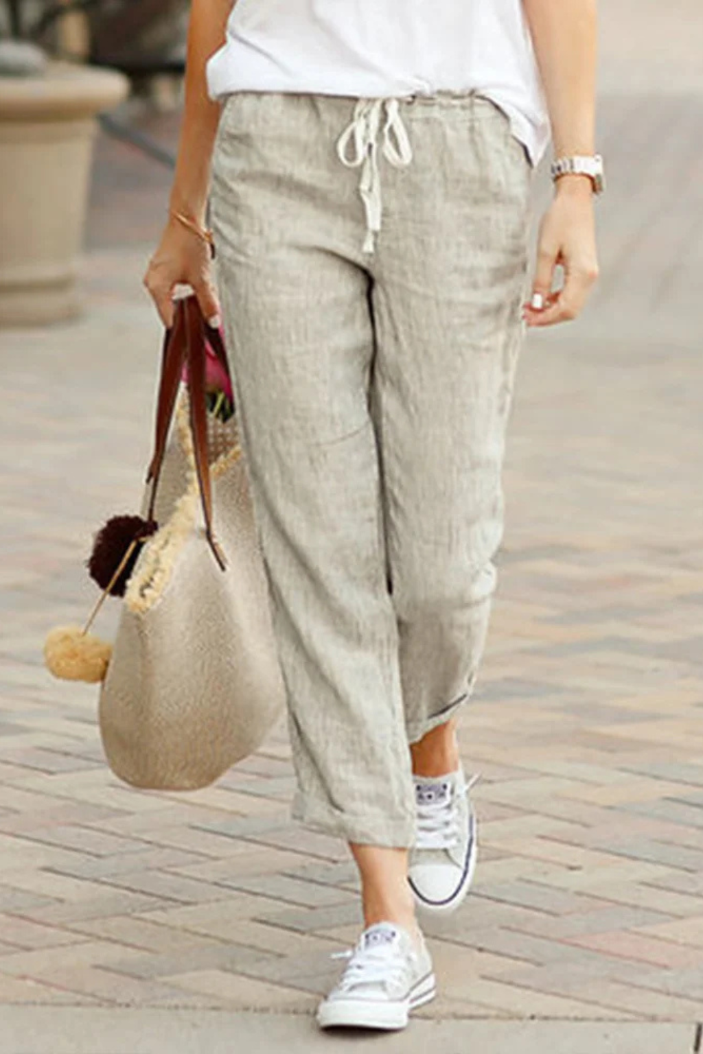 Breathable linen blend cropped trousers for women, featuring a stylish drawstring waist for adjustable comfort.