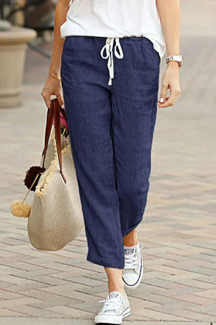 Comfortable ladies' cropped linen trousers with an elastic drawstring waist, essential for relaxed warm-weather style.