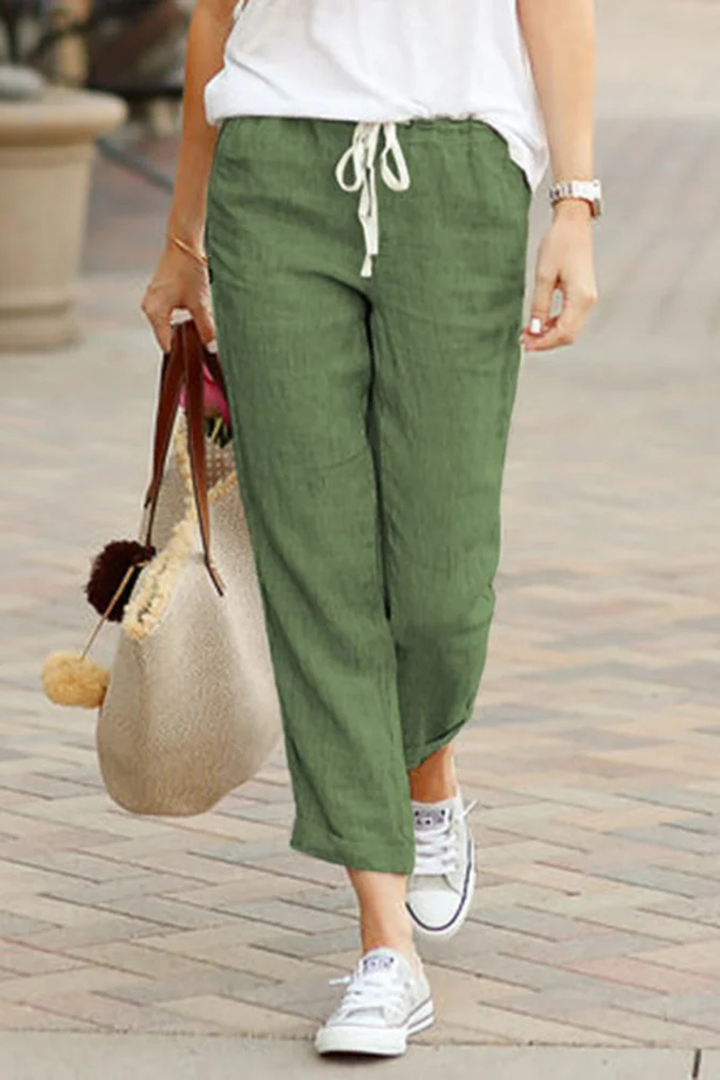 Fashionable women's cropped linen trousers with a chic drawstring waist, ideal for versatile styling.