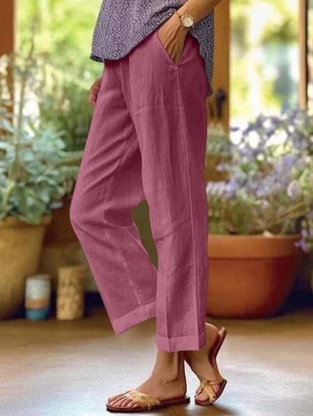 Stylish women's cropped linen trousers with tapered fit, providing ultimate summer comfort and lightweight feel.