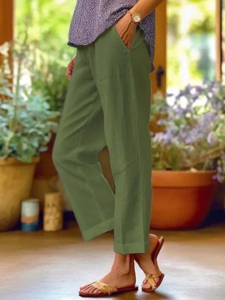 Women's summer linen trousers, tapered and cropped, with cuffed detail for a chic, lightweight casual look.