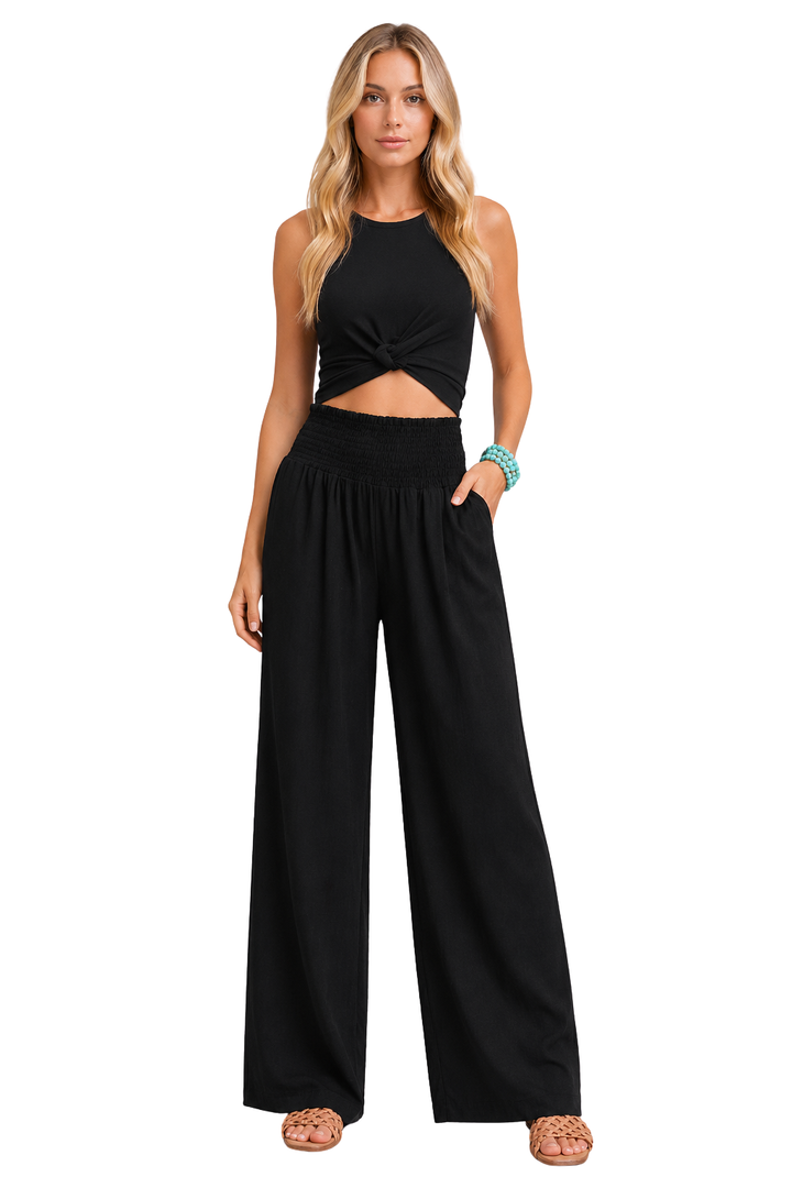 Close-up of shirred elastic waist detail on women's natural linen wide leg trousers.