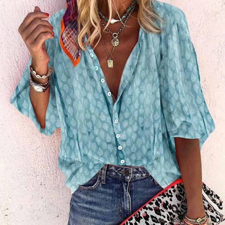 Women's lively print button-down blouse, perfect for casual summer fashion. Relaxed long-sleeve top.