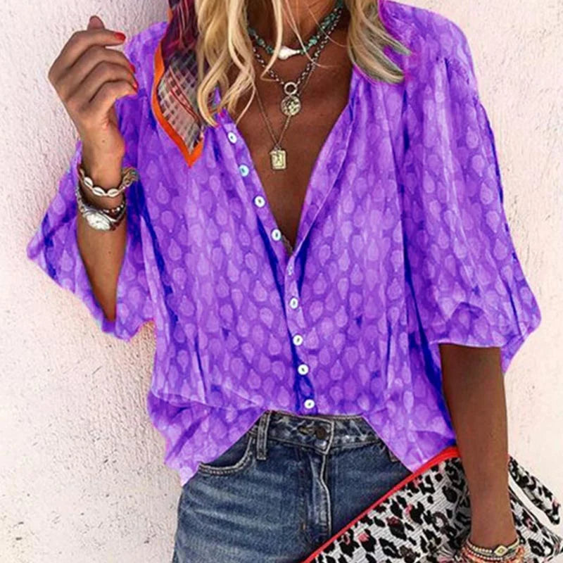 Relaxed fit women's button-down blouse with a vibrant print. Comfortable long-sleeve top for summer.