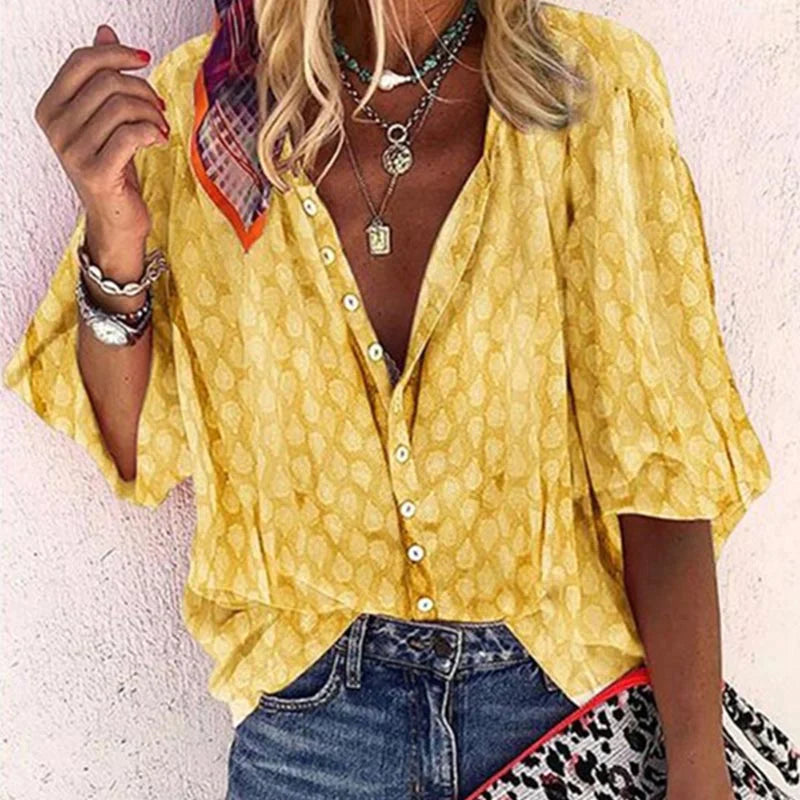 Cheerful printed women's button-down blouse. Long-sleeve summer top with a lively pattern.