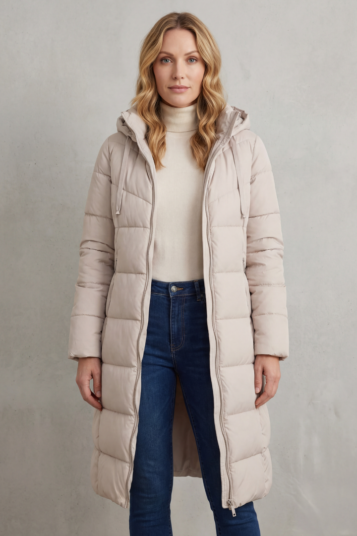 Stylish women's extended length quilted puffer coat in ivory, perfect for cozy winter outerwear.