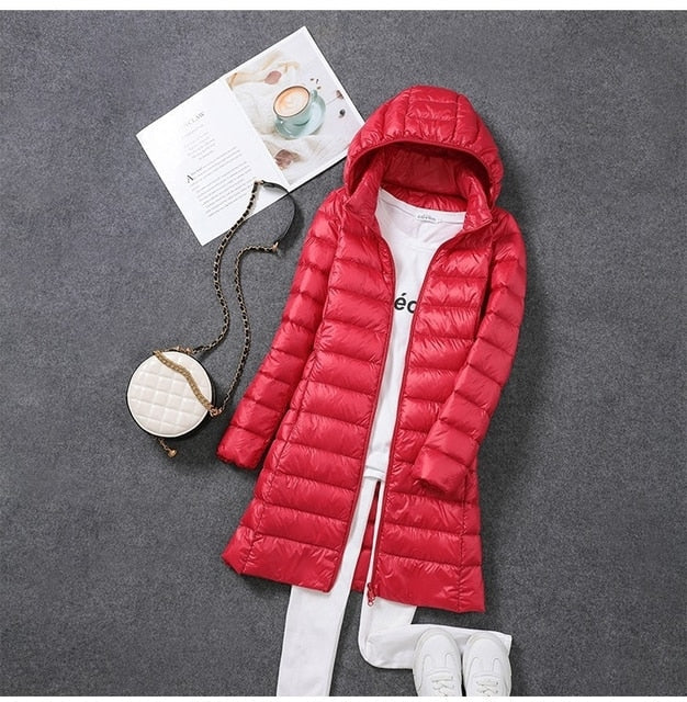 Stylish women's long puffer jacket, insulated for ultimate winter warmth. Features a chic design & detachable hood.