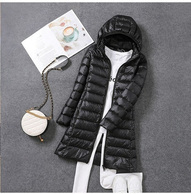 New women's long down coat, a warm puffer jacket with a detachable hood, designed for extreme winter cold.