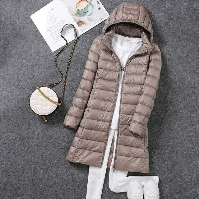 Full-length women's down puffer jacket, offering superior winter warmth & protection. Includes a detachable hood.