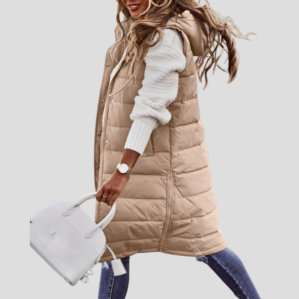 Versatile women's long hooded bodywarmer, ideal for layering outfits. Essential fall & winter fashion outerwear.