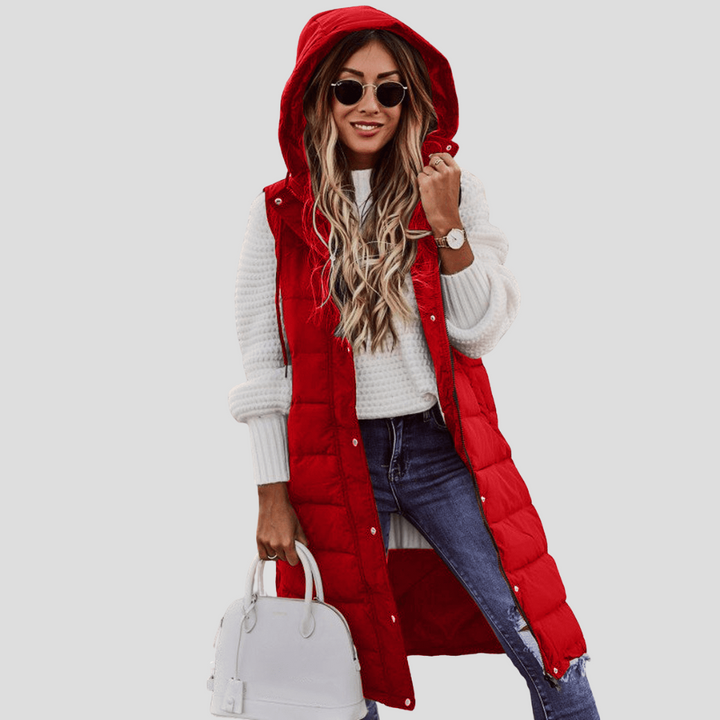 Modern women's long hooded bodywarmer with a flattering longline cut. Perfect padded vest for casual outerwear.