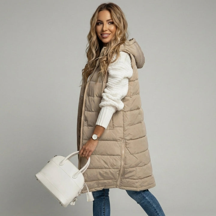 Casual chic women's long hooded bodywarmer. Comfortable padded vest for cold weather and everyday style.
