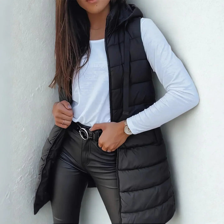 Women's long hooded puffer vest, lightweight & sleeveless, perfect for casual fall & winter layering.